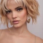 Blonde, textured bob wig with layered bangs and wavy style.